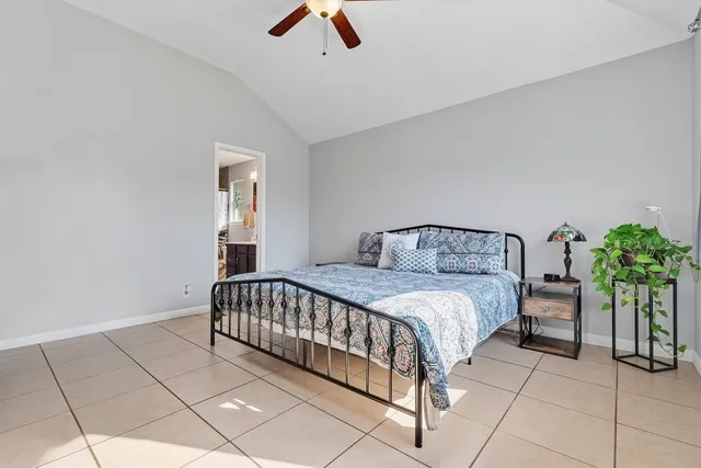 a bedroom with a bed and a potted plant