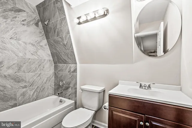 a bathroom with a sink a toilet and bathtub