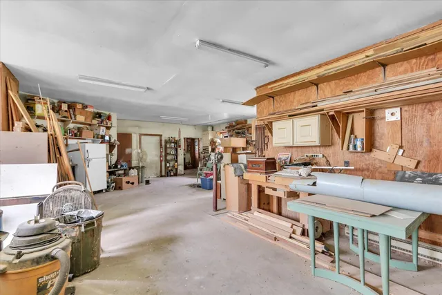 a room with lots of wooden furniture and a large window