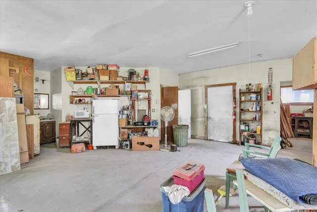 a living room with furniture and a book shelf