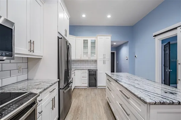 a kitchen with a stove a sink and a refrigerator
