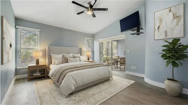 a spacious bedroom with a bed and a potted plant