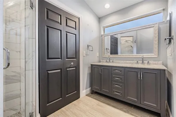 a bathroom with a double vanity sink and mirror