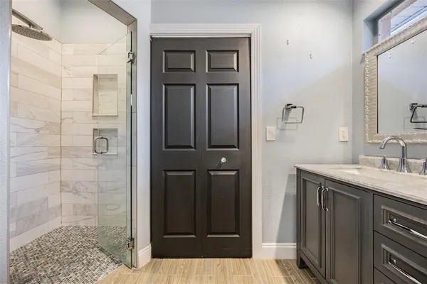 a bathroom with a granite countertop sink and a mirror