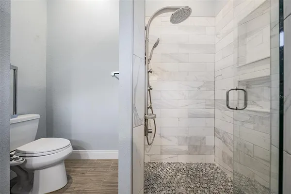 a bathroom with a toilet and a shower