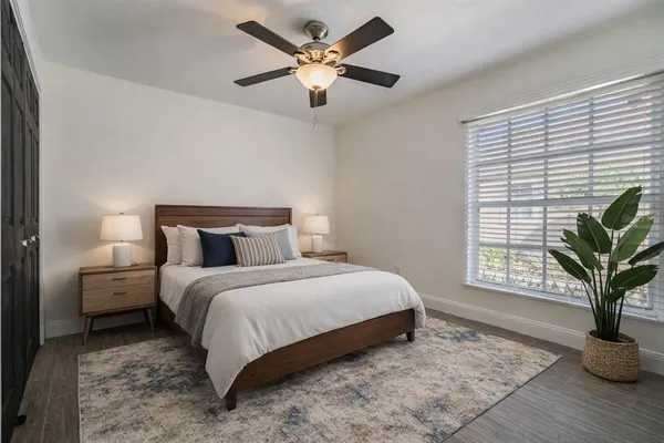 a bedroom with bed and a large window