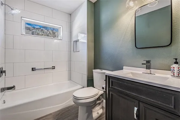 a bathroom with a toilet a sink and bathtub