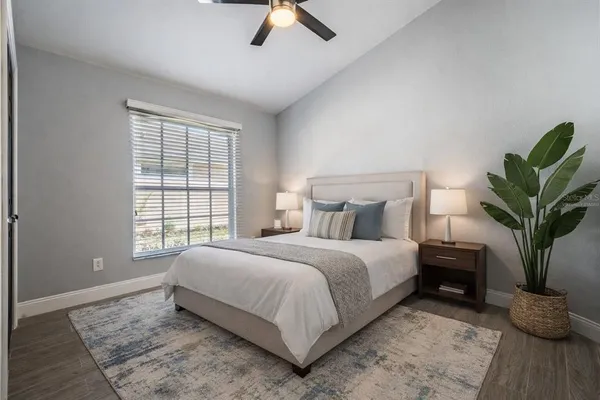 a bedroom with a large bed and a chandelier