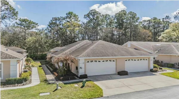a view of a white house with a sink and a yard