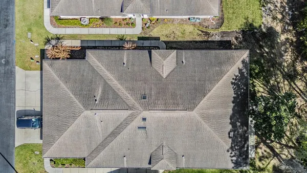 an aerial view of a house with swimming pool and big yard