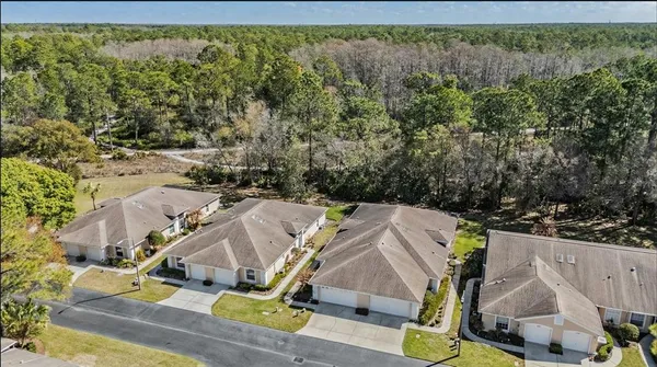an aerial view of a house with swimming pool and porch