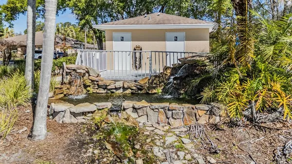a view of roof deck with wooden fence and trees