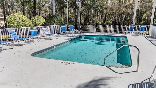 a view of house with swimming pool outdoor seating