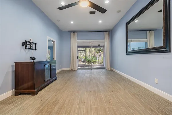 an empty room with windows and cabinet