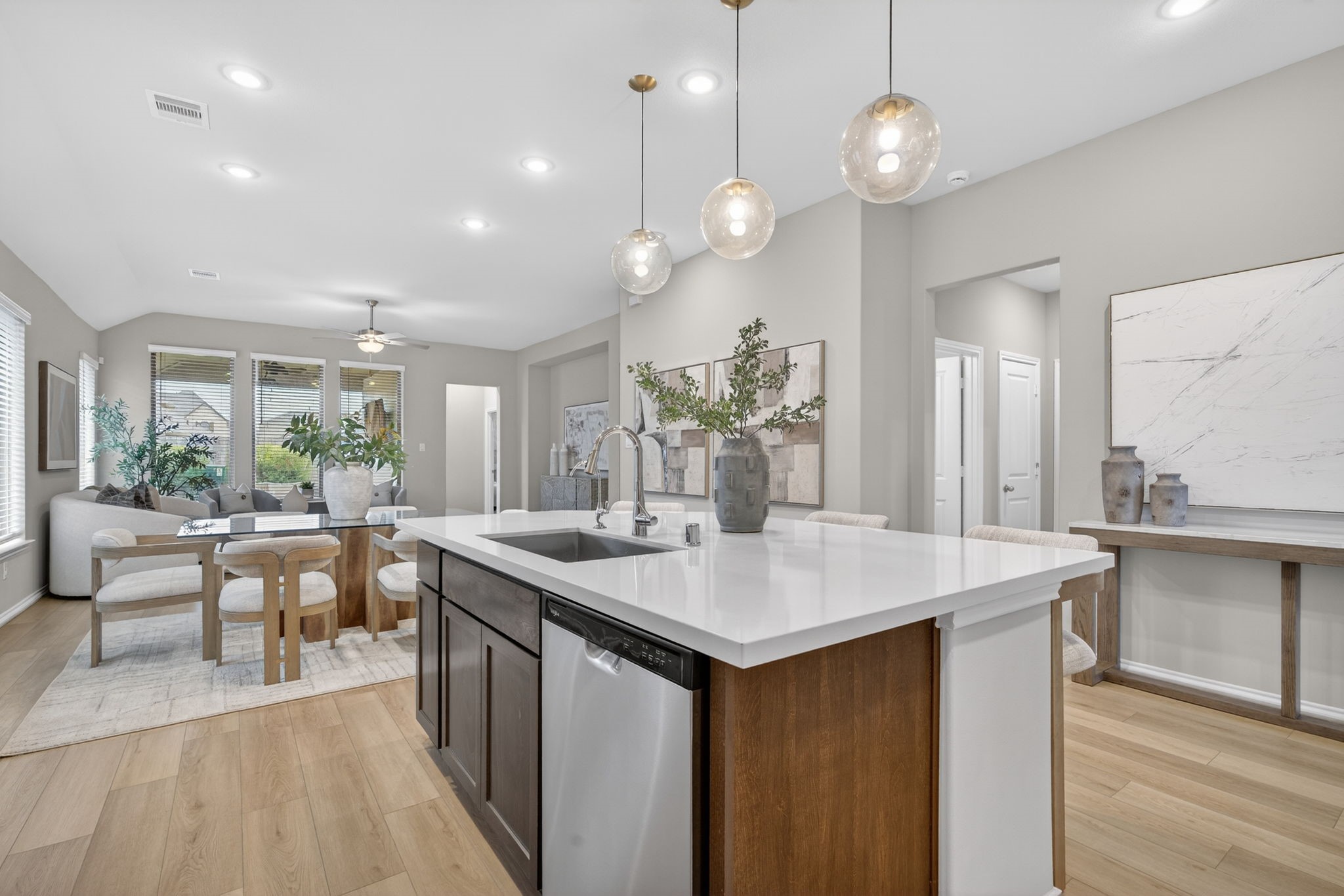 31731 Redbud Blossom Lane Spring, TX 77386 - Photo 11 of 38 This modern, open-concept kitchen and dining area. It flows into a bright living space with ample natural light from multiple windows, creating a welcoming and spacious environment.