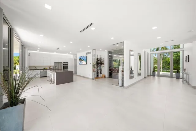a living room with furniture floor to ceiling window and a floor to ceiling window