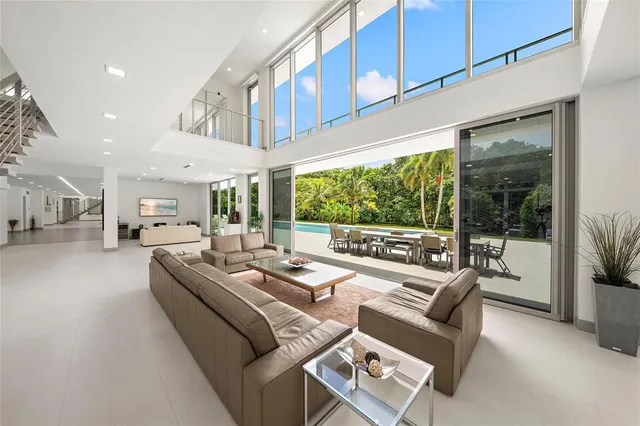 a living room with furniture and large windows