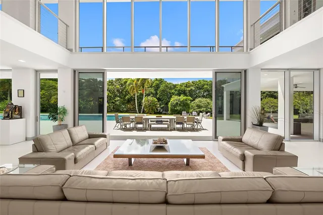 a dining room with furniture and a floor to ceiling window