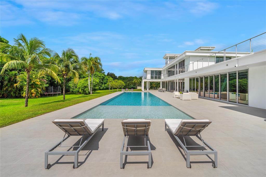 17250 Southwest 52nd Court Southwest Ranches, FL 33331 - Photo 23 of 62 a view of a swimming pool with a lounge chair