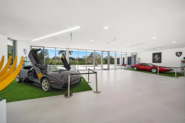 a room with lots of furniture and view of kitchen