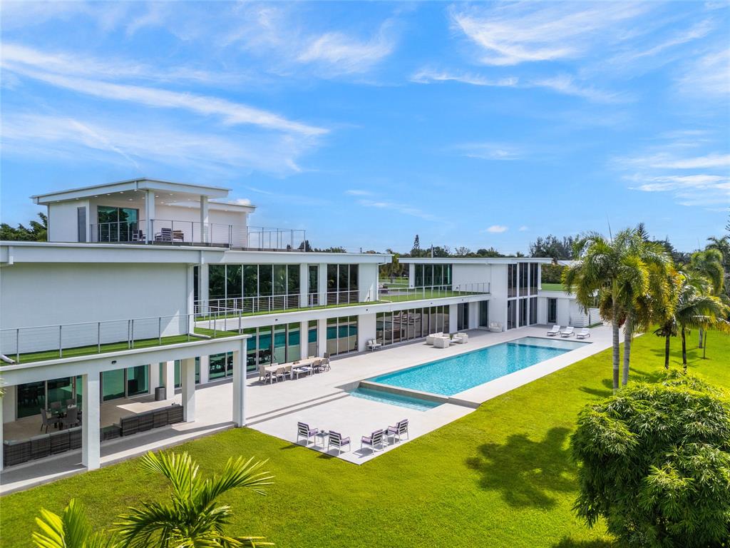 17250 Southwest 52nd Court Southwest Ranches, FL 33331 - Photo 4 of 62 a view of a swimming pool with a lounge chairs