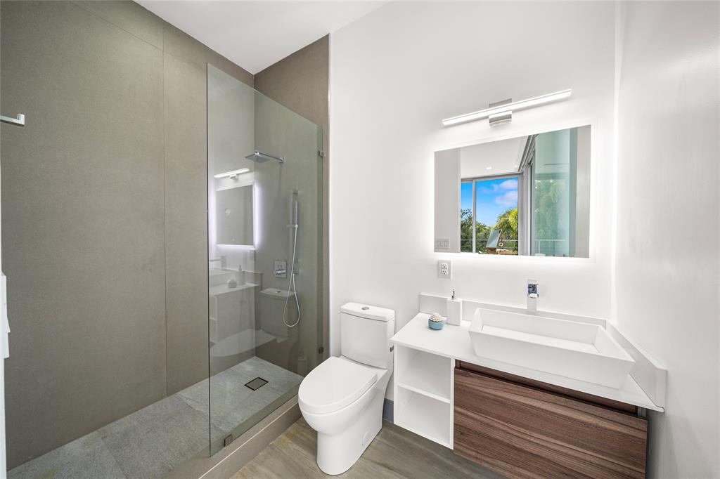 17250 Southwest 52nd Court Southwest Ranches, FL 33331 - Photo 51 of 62 a bathroom with a sink toilet a mirror and shower