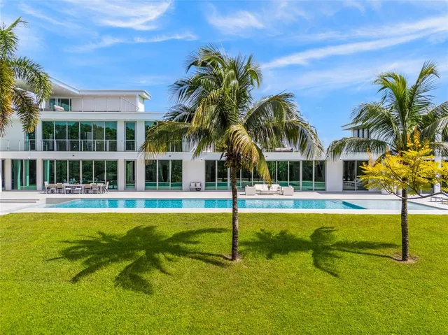 an aerial view of a swimming pool with seating area