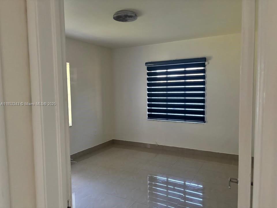 5740 Southwest 60th Street Miami, FL 33143 - Photo 2 of 7 a view of room and window