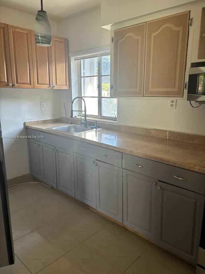 5740 Southwest 60th Street Miami, FL 33143 - Photo 6 of 7 a kitchen with sink and cabinets