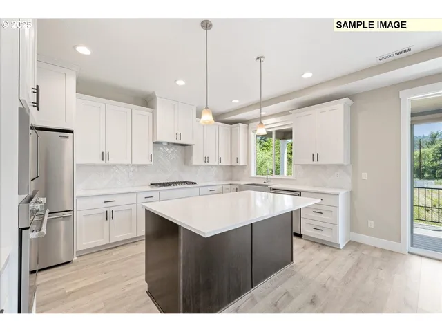 a kitchen with white cabinets sink and stainless steel appliances