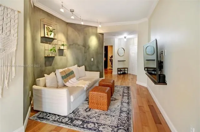 a large room with mirror and furniture