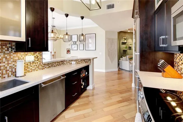 a kitchen with stainless steel appliances granite countertop a sink and cabinets