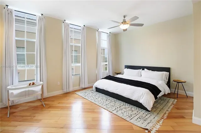 a bedroom with a large bed and a window