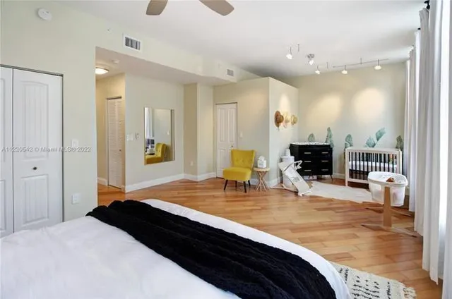 a bedroom with a bed a mirror and city view