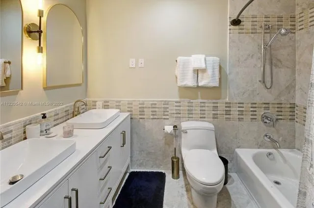 a bathroom with a sink a toilet and bathtub
