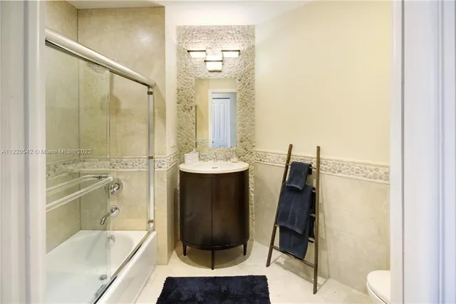 a bathroom with a tub sink and mirror