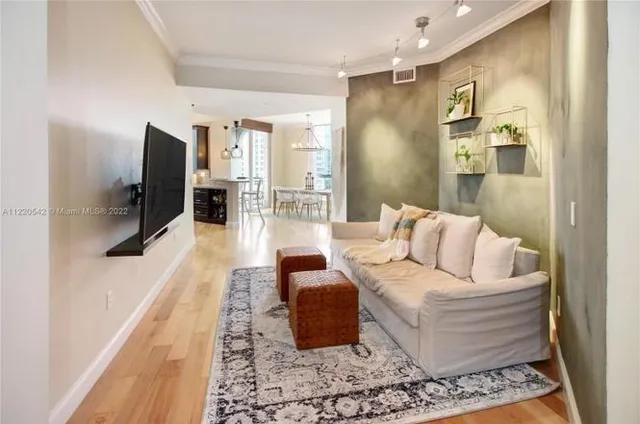 a living room with furniture and wooden floor
