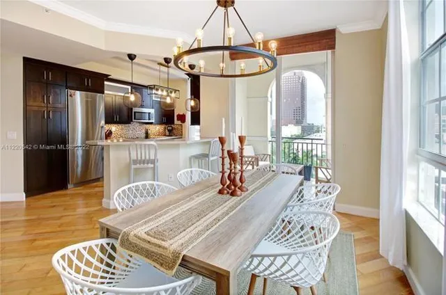 a dining room with furniture a chandelier and wooden floor