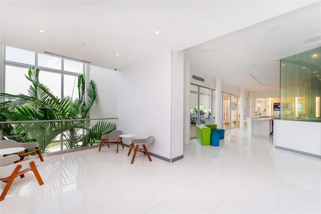 a living room with furniture and potted plants