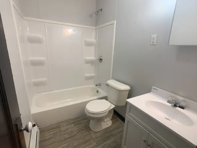 a white toilet sitting next to a bathroom sink