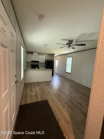 a view of a hallway view with wooden floor