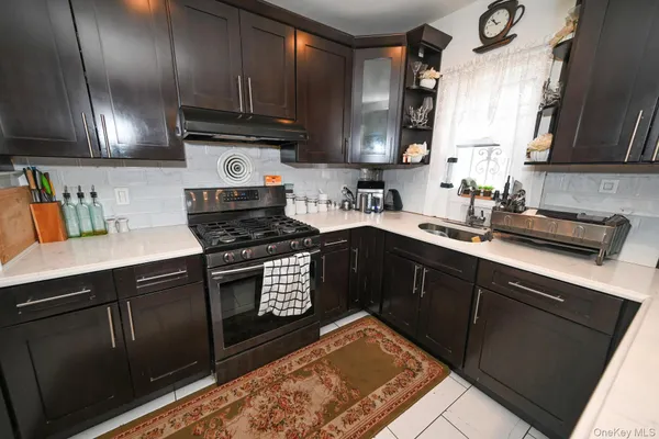 a kitchen with stainless steel appliances granite countertop a sink stove and cabinets