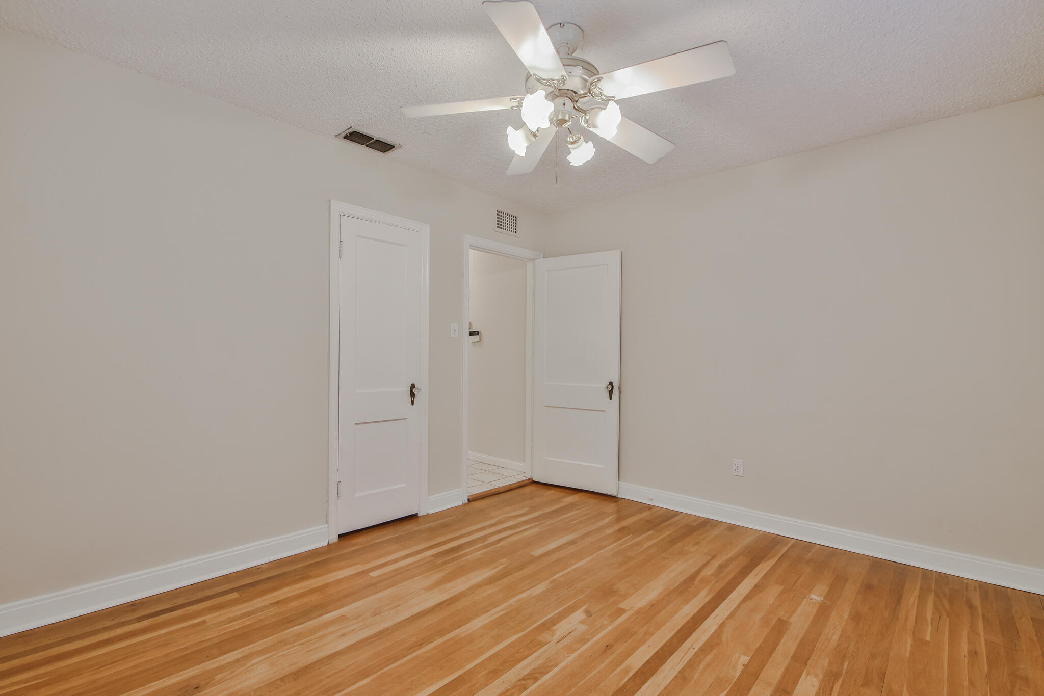 2715 29th Street Lubbock, TX 79410 - Photo 11 of 35 wooden floor in an empty room
