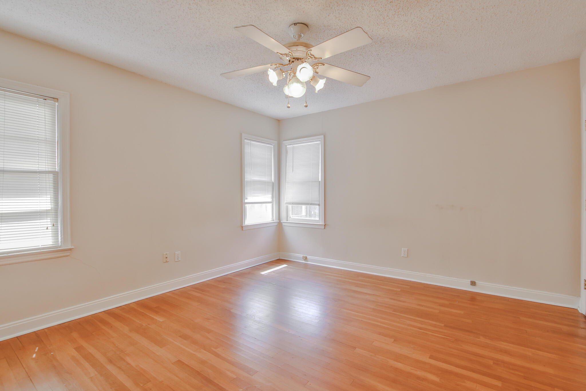 2715 29th Street Lubbock, TX 79410 - Photo 15 of 35 a view of an empty room with wooden floor and a window