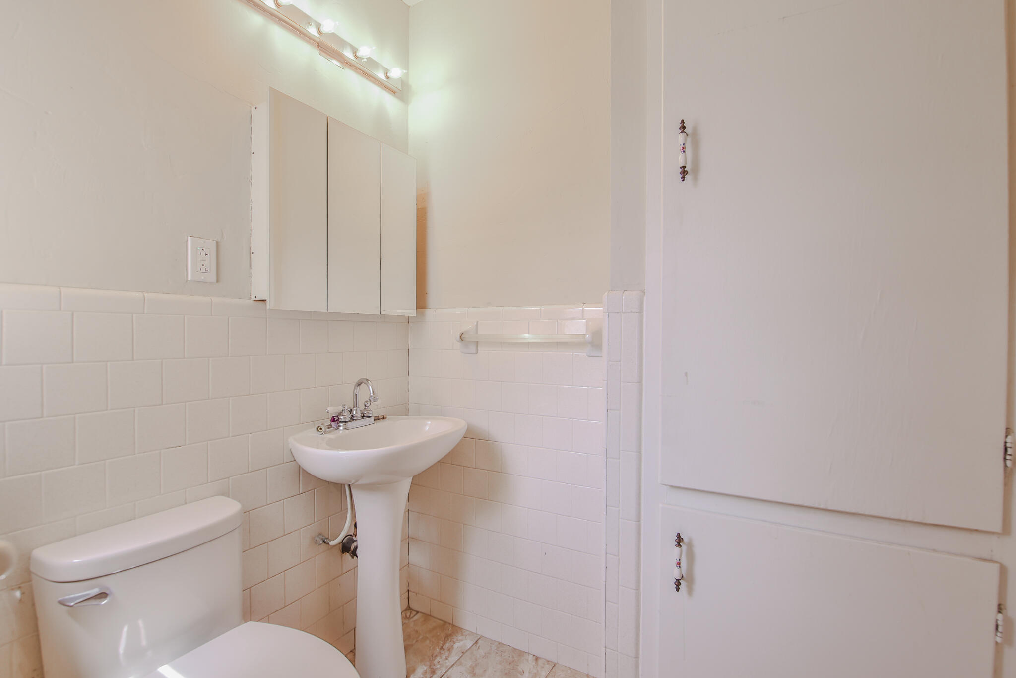 2715 29th Street Lubbock, TX 79410 - Photo 19 of 35 a bathroom with a sink mirror and toilet