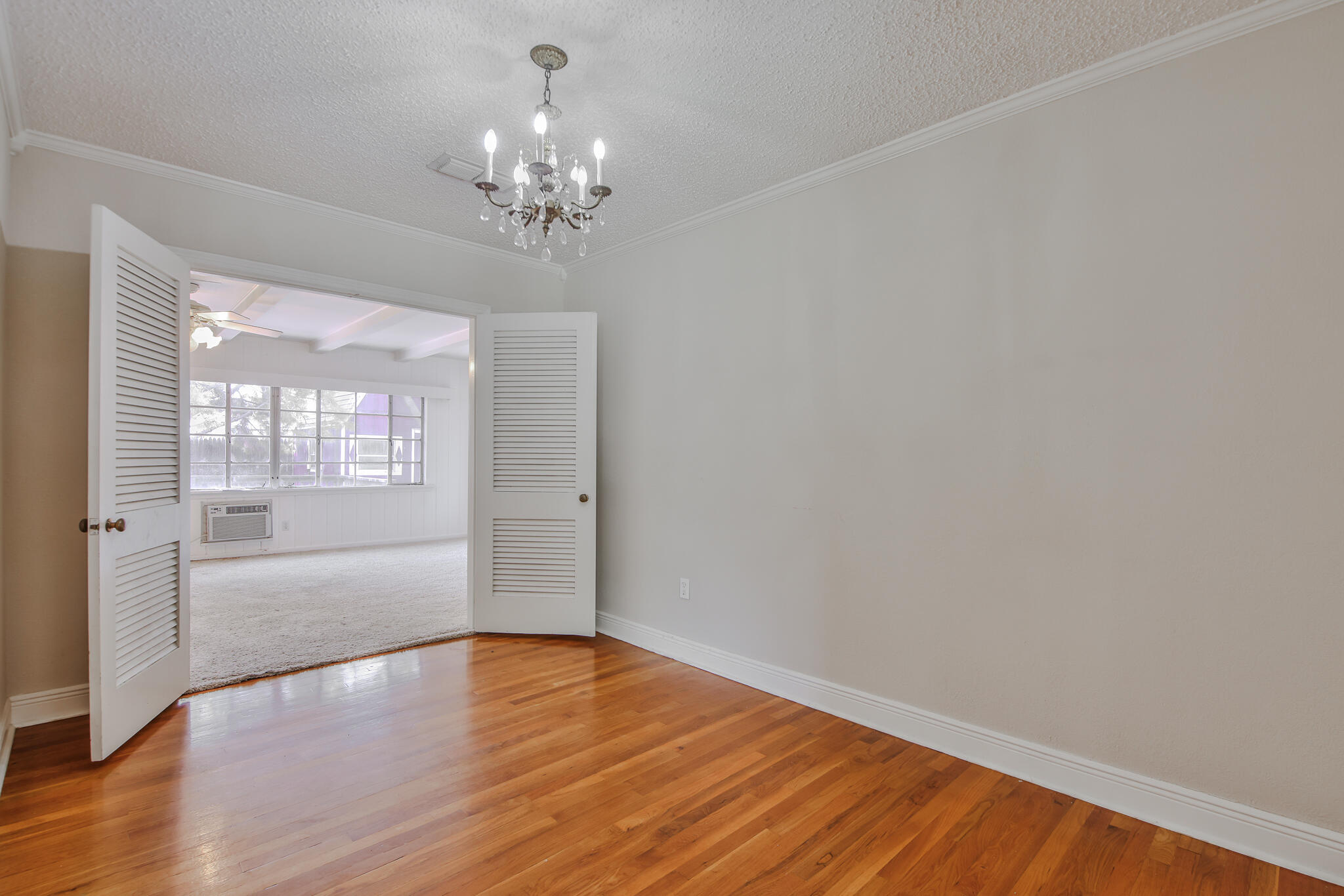 2715 29th Street Lubbock, TX 79410 - Photo 20 of 35 a view of an empty room with wooden floor and a window