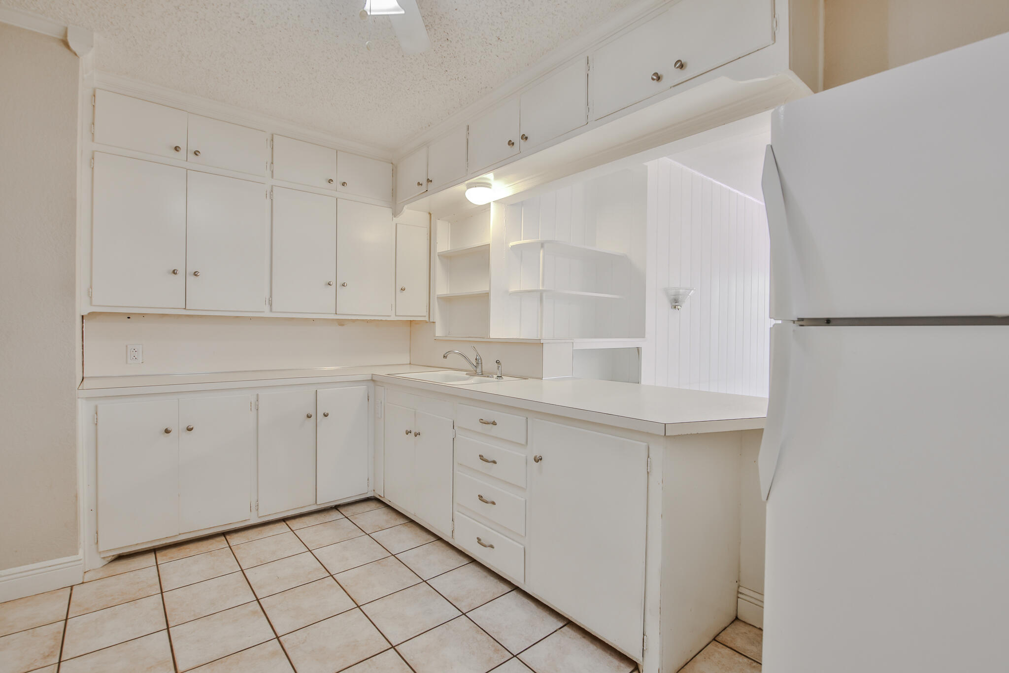 2715 29th Street Lubbock, TX 79410 - Photo 21 of 35 a kitchen with white cabinets