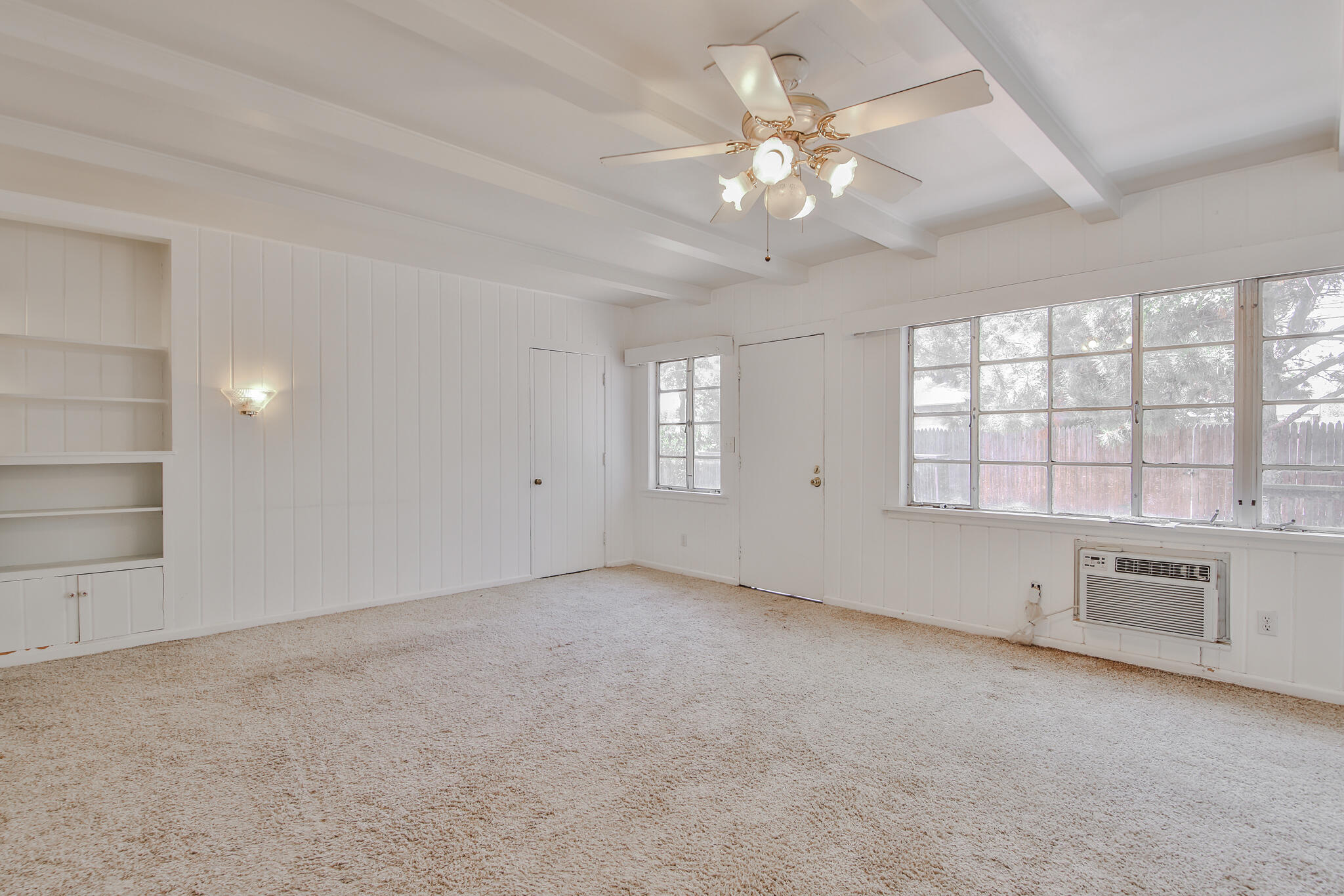 2715 29th Street Lubbock, TX 79410 - Photo 25 of 35 an empty room with chandelier fan and windows