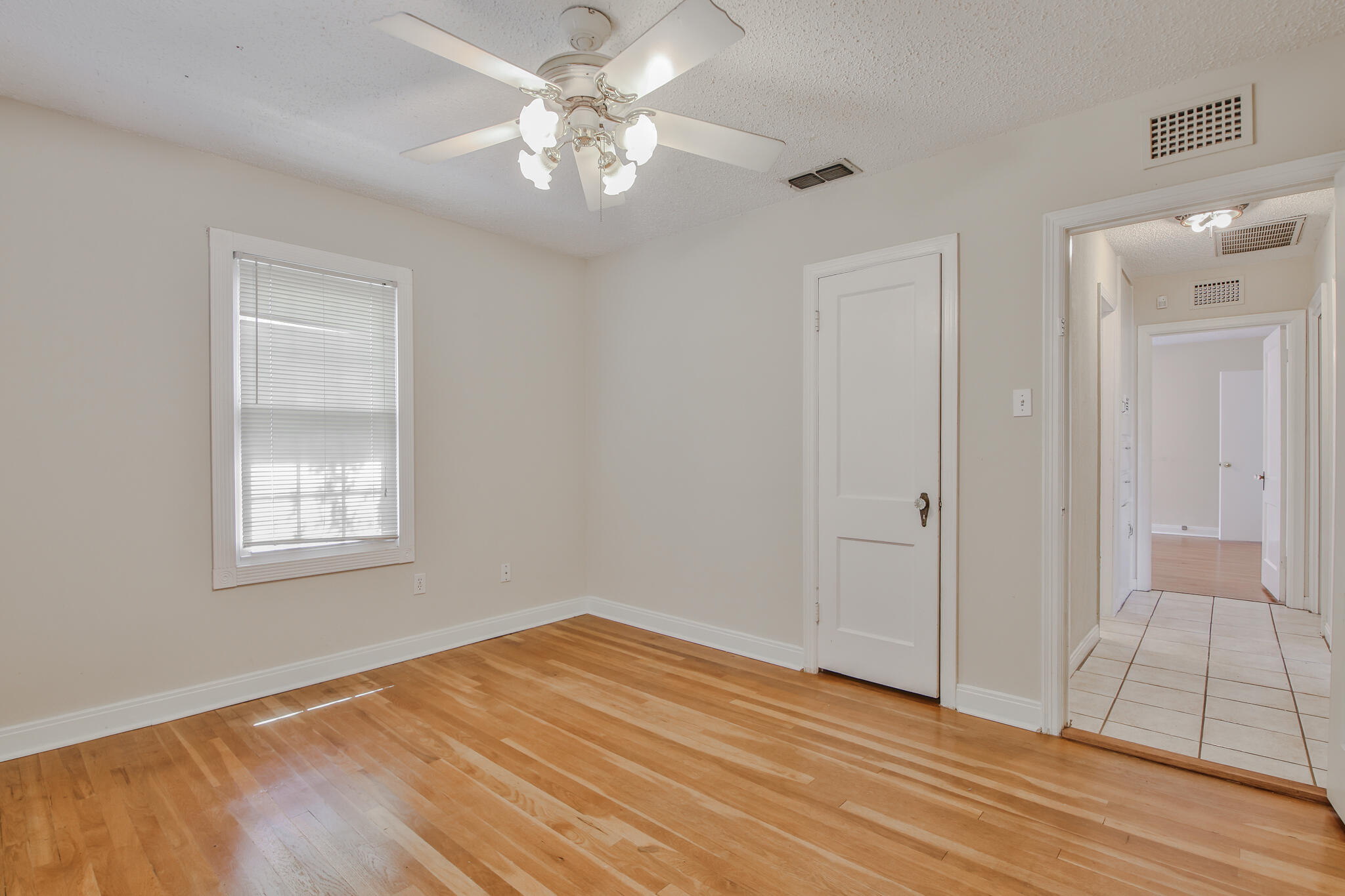 2715 29th Street Lubbock, TX 79410 - Photo 10 of 35 wooden floor in an empty room with a window