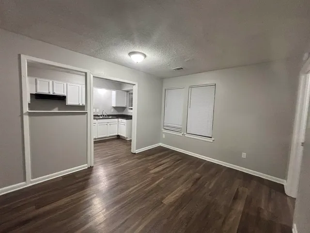 a view of a kitchen with a sink and a refrigerator